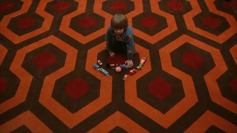 In this shot, most likely a pick-up, the pattern on the carpet is oriented so that the “opening” of the hexagon is in front of Danny.
